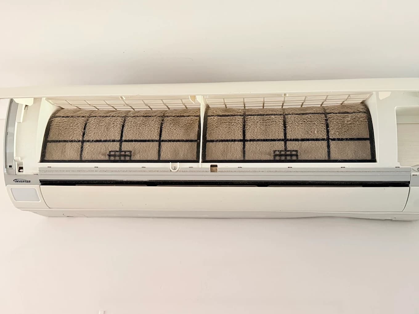 Aircon filter heavily caked in dust before cleaning